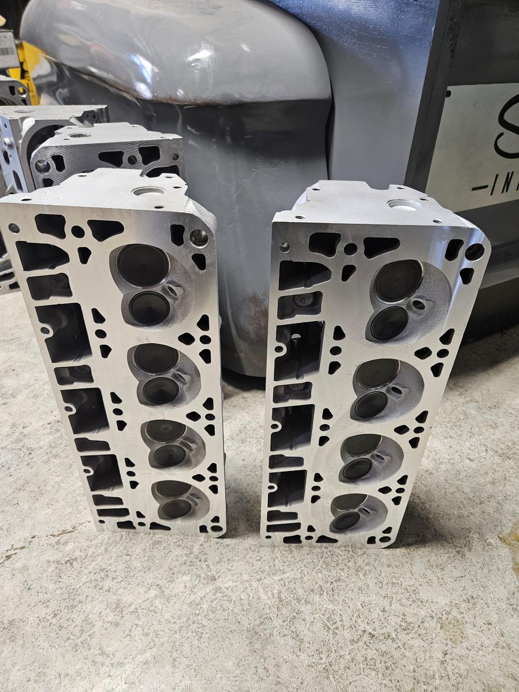 Pair of refreshed cylinder heads standing on the shop floor